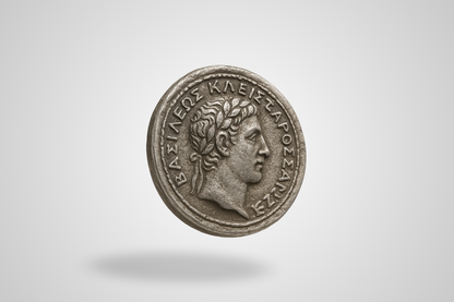 A photo of an antique metal coin in silver with embossing